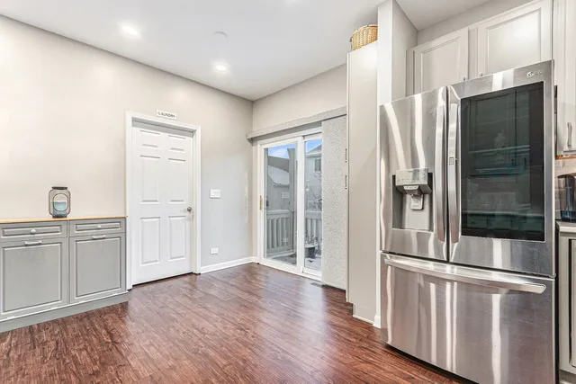 a kitchen with stainless steel appliances a refrigerator and wooden cabinets