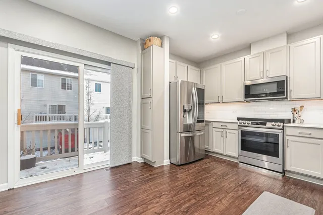 a kitchen with stainless steel appliances granite countertop a refrigerator and a stove top oven