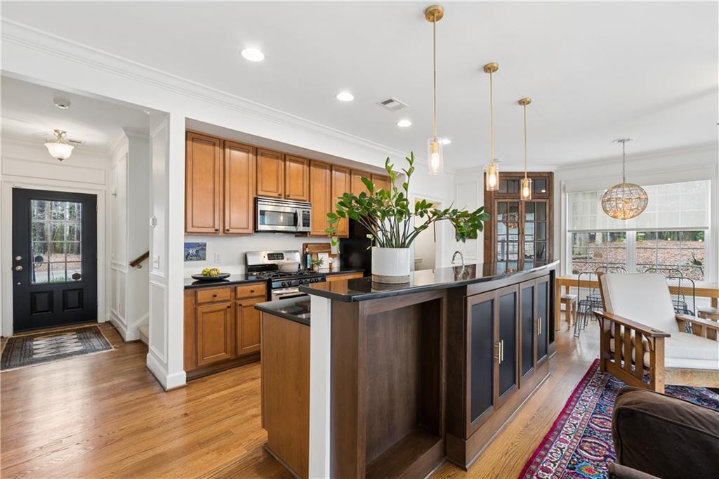 2838 Jordan Oaks Lane Decatur, GA 30033 - Photo 11 of 39 a kitchen with stainless steel appliances granite countertop a sink a stove and a wooden floors
