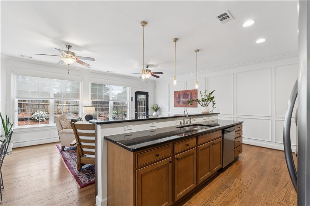 2838 Jordan Oaks Lane Decatur, GA 30033 - Photo 12 of 39 a kitchen with stainless steel appliances granite countertop a sink a stove and a wooden floors