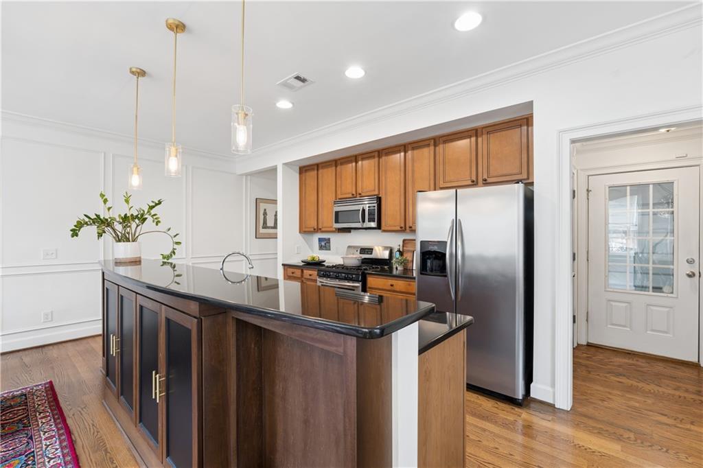2838 Jordan Oaks Lane Decatur, GA 30033 - Photo 13 of 39 a kitchen with stainless steel appliances granite countertop a refrigerator a sink dishwasher a stove and white countertops with wooden floor