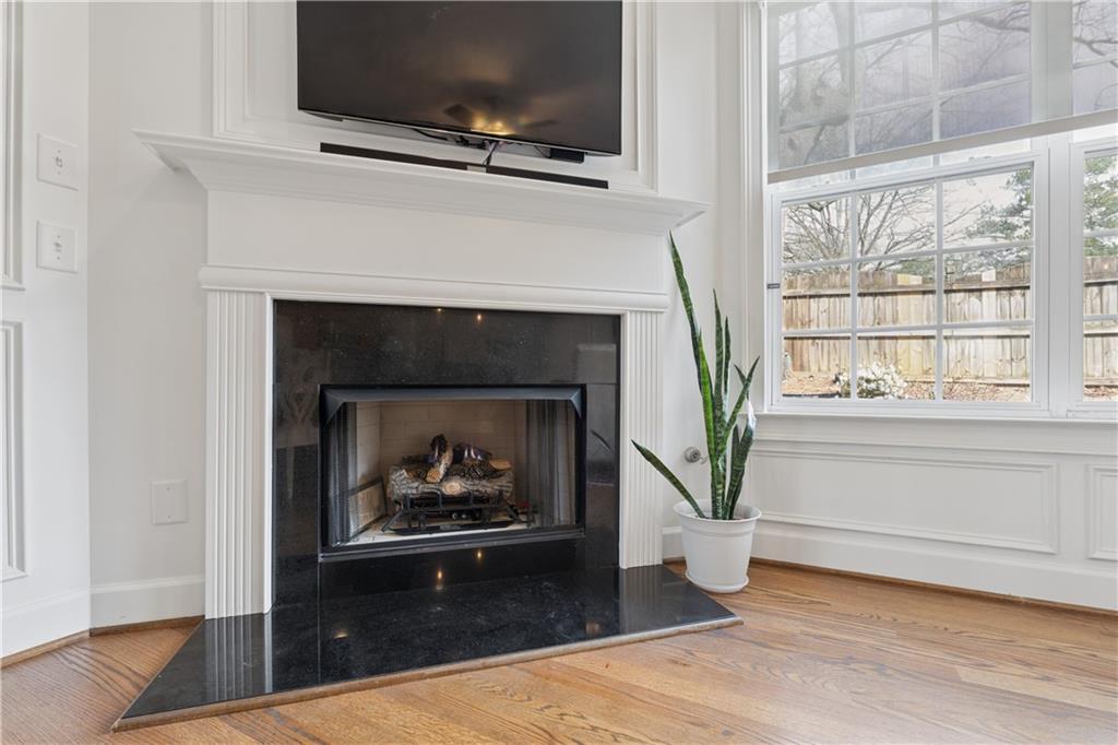 2838 Jordan Oaks Lane Decatur, GA 30033 - Photo 20 of 39 a living room with a fireplace a flat screen tv and a window