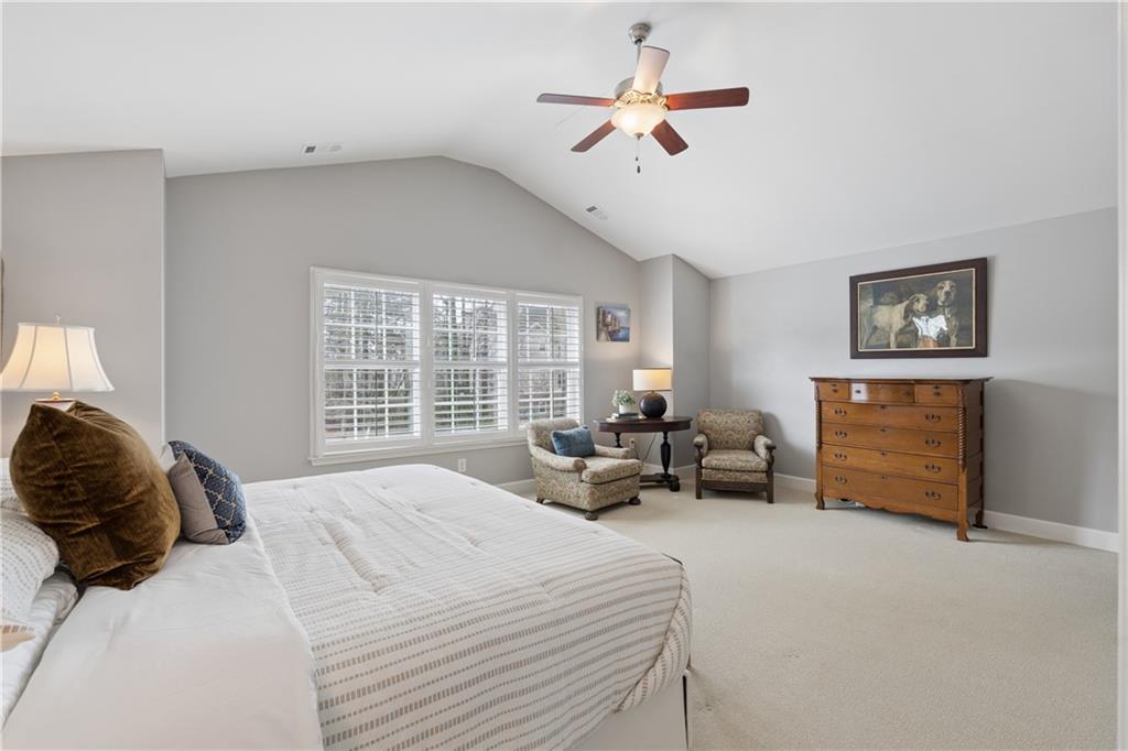 2838 Jordan Oaks Lane Decatur, GA 30033 - Photo 24 of 39 a bedroom with a bed a dresser and a chandelier