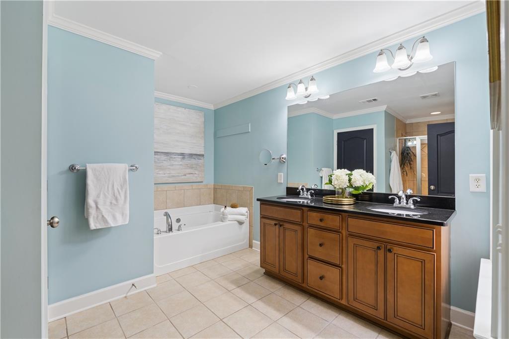 2838 Jordan Oaks Lane Decatur, GA 30033 - Photo 6 of 39 a spacious bathroom with a granite countertop sink mirror and a bathtub