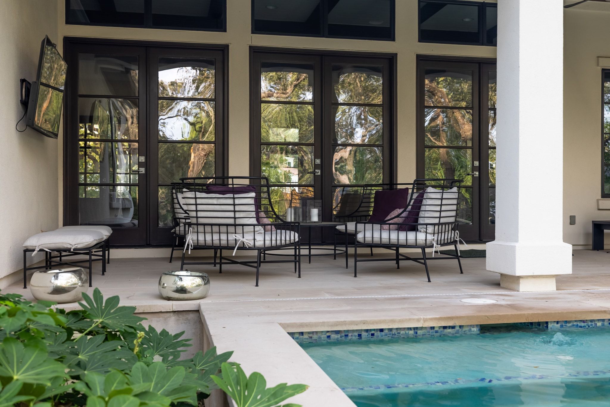 4720 Rockcliff Road, Unit 1 Austin, TX 78746 - Photo 6 of 39 An inviting outdoor lounge area features poolside seating with direct access to interior living spaces.