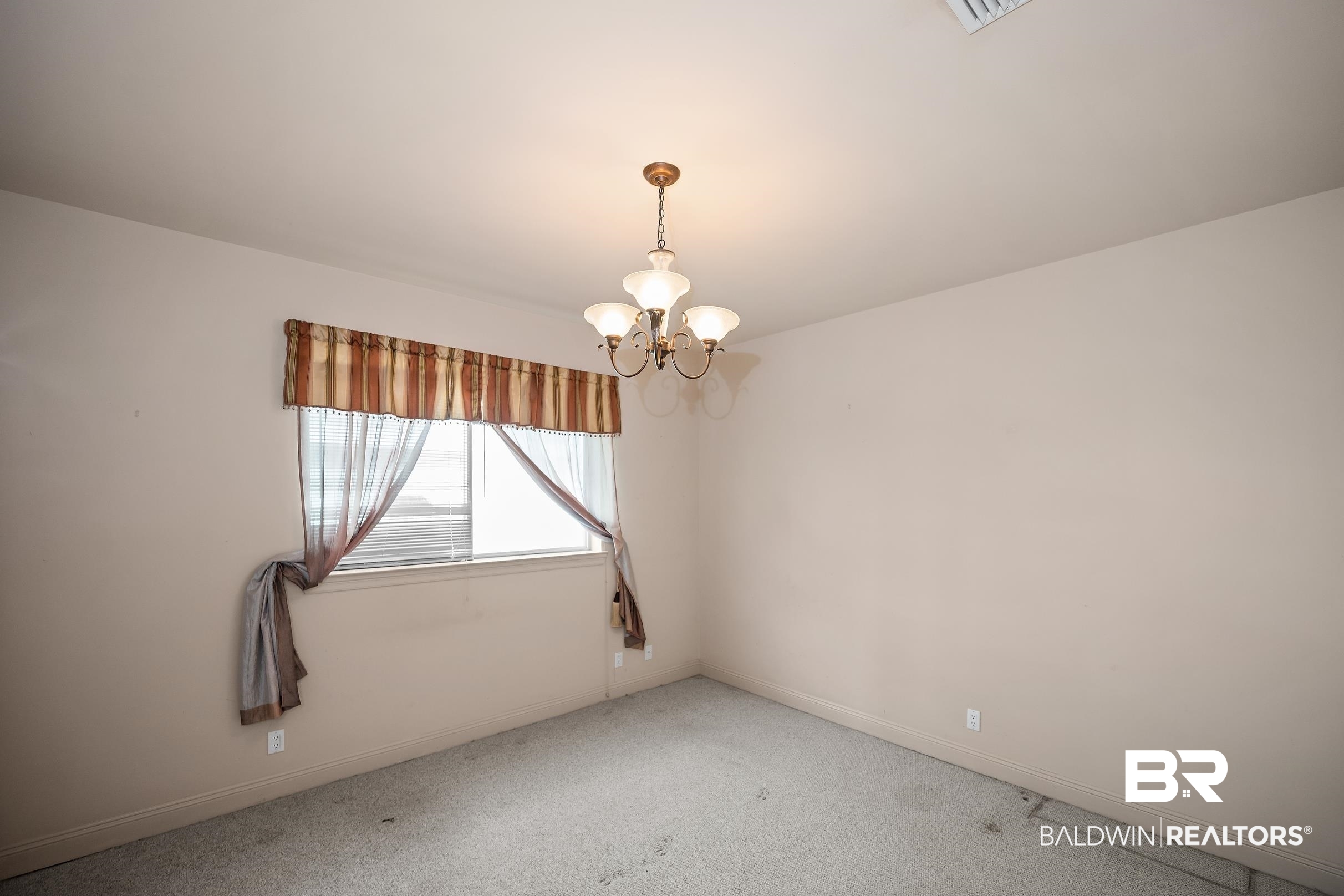 8591 Bay Harbor Road Elberta, AL 36530 - Photo 35 of 56 Spare room with carpet flooring and a chandelier