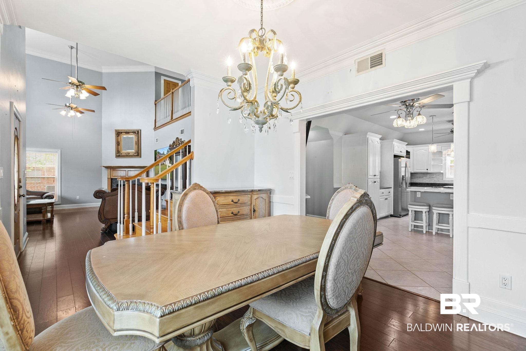2 Speckle Trout Route Daphne, AL 36527 - Photo 13 of 61 Dining area featuring a ceiling fan, light wood-style floors, hanging lights, crown molding, and a high ceiling