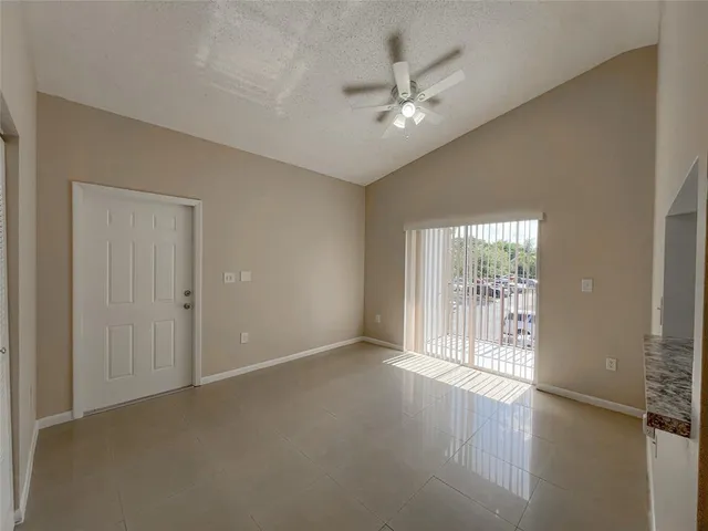 a view of an empty room with glass door