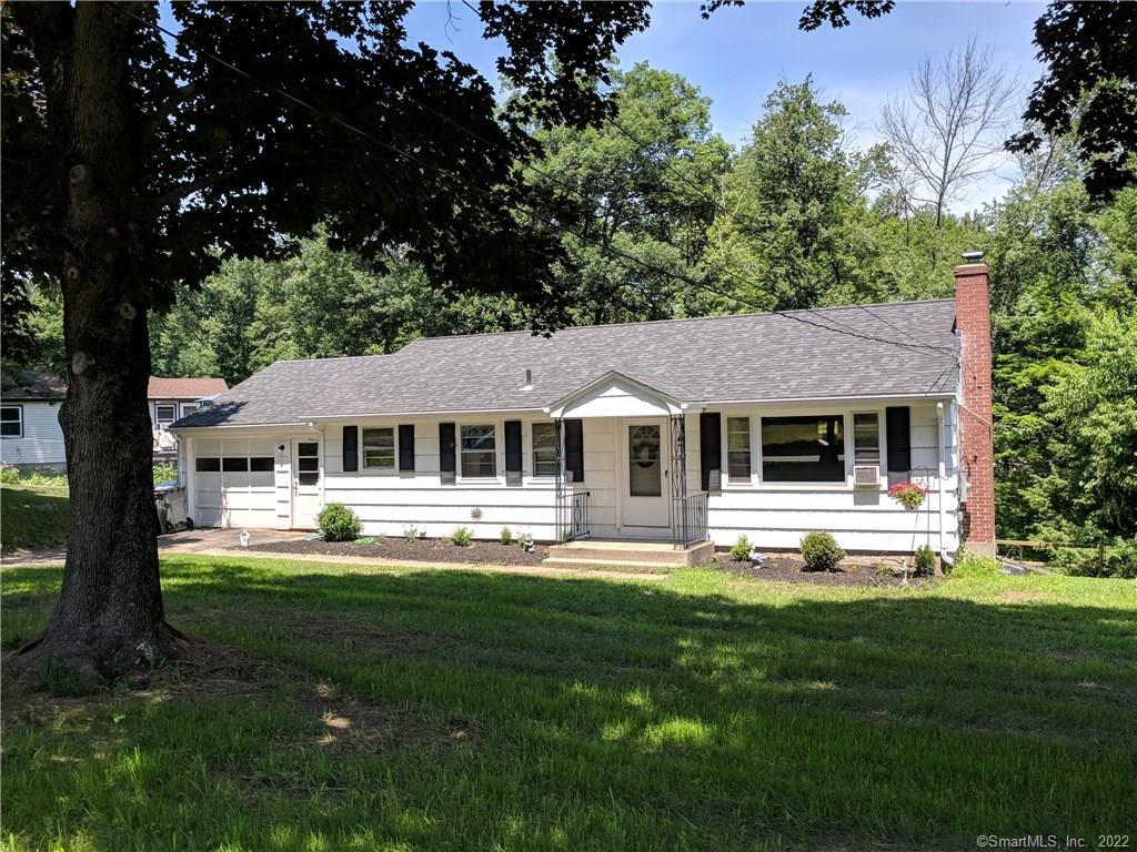 a front view of a house with a yard table and chairs