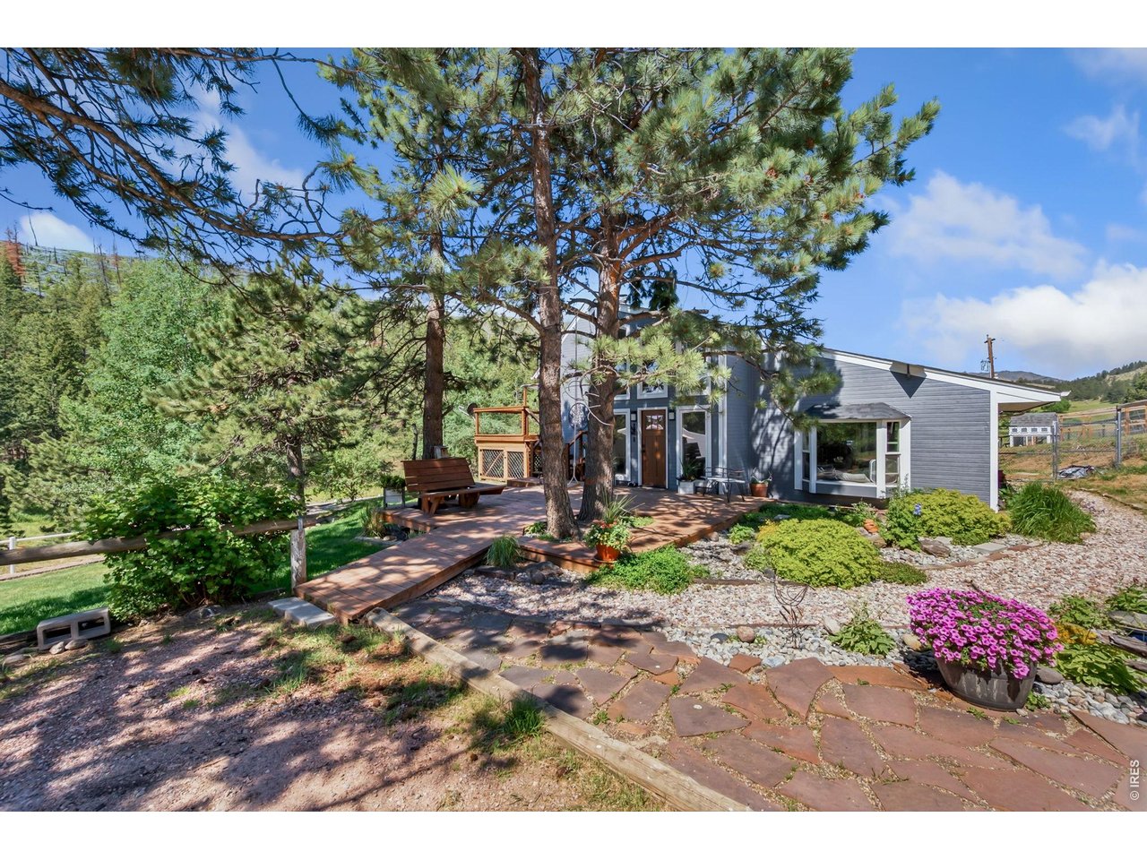 1154 Spring Valley Road Bellvue, CO 80512 - Photo 4 of 31 Beautiful, mature landscaping, flagstone, newer decking