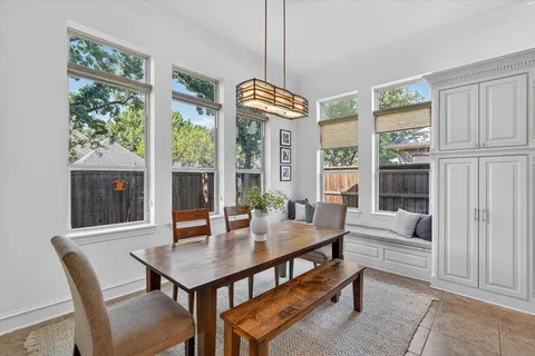 a view of a dining room with furniture large windows and wooden floor