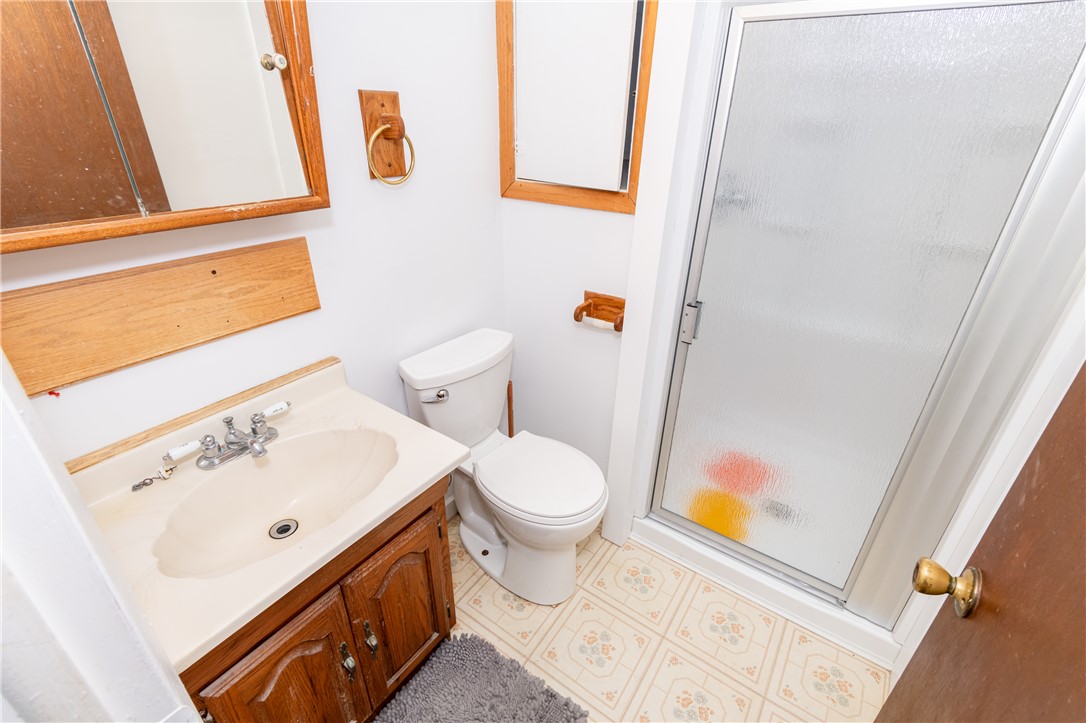 5760 Kitridge Road Dayton, OH 45424 - Photo 8 of 19 This bathroom features a functional vanity and a convenient stand-up shower