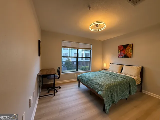 a living room with a bed furniture and a window
