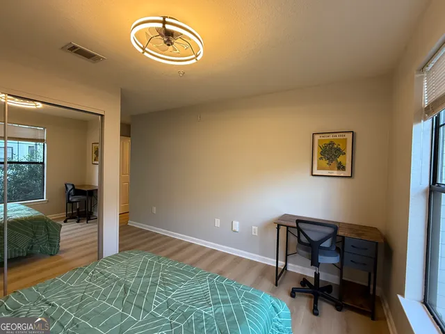 a view of a workspace with furniture and a bedroom