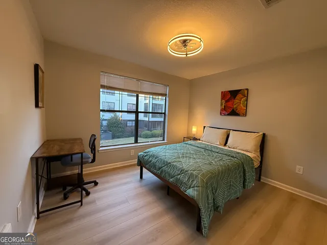 a bed sitting in a bedroom next to a window