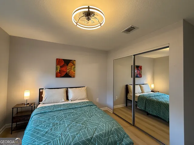 a bedroom with a bed and a mirror