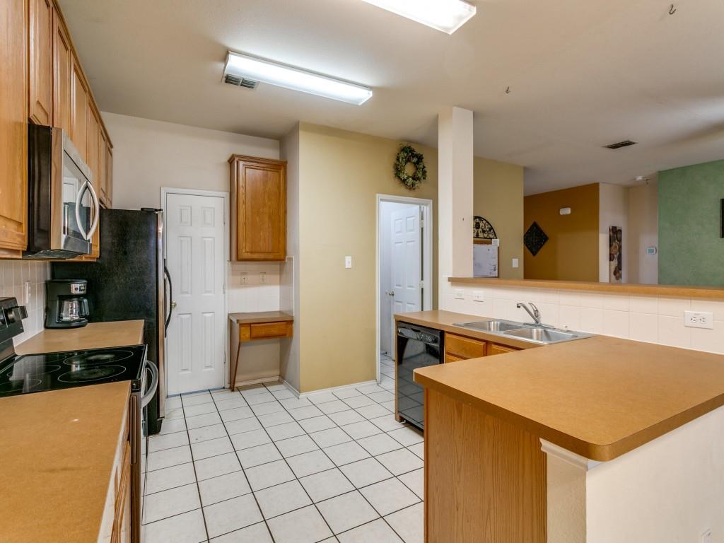 1105 Riverside Drive Lewisville, TX 75067 - Photo 17 of 40 a kitchen with stainless steel appliances a stove a sink and a refrigerator