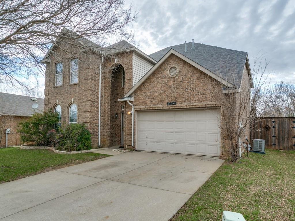 1105 Riverside Drive Lewisville, TX 75067 - Photo 2 of 40 a front view of a house with a garden and garage