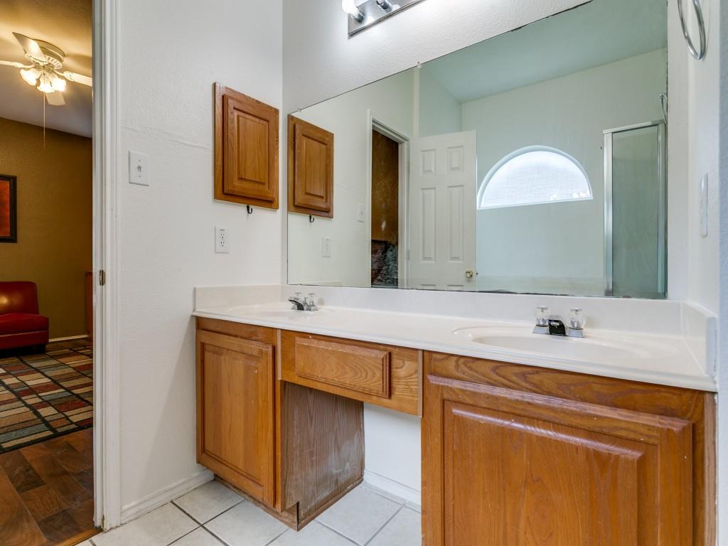 1105 Riverside Drive Lewisville, TX 75067 - Photo 23 of 40 a bathroom with a sink and a mirror