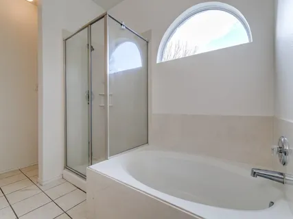 a bathroom with a tub and shower