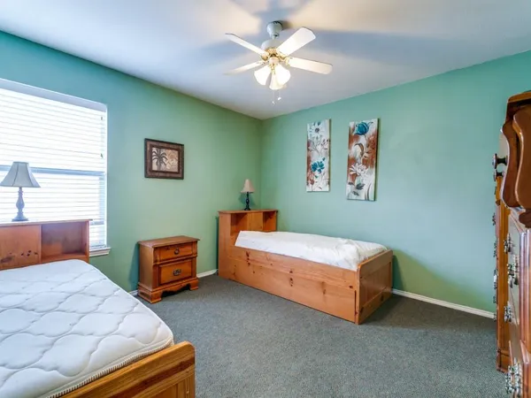 a bedroom with 2 bed and a chandelier