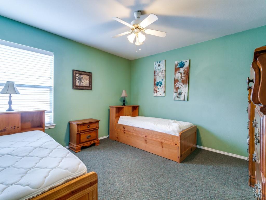1105 Riverside Drive Lewisville, TX 75067 - Photo 32 of 40 a bedroom with 2 bed and a chandelier