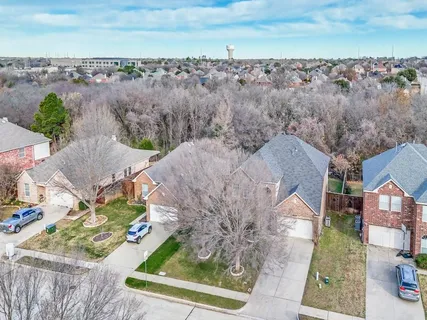 a view of a house with a yard and lake view