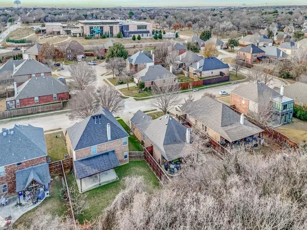 an aerial view of a house with a yard