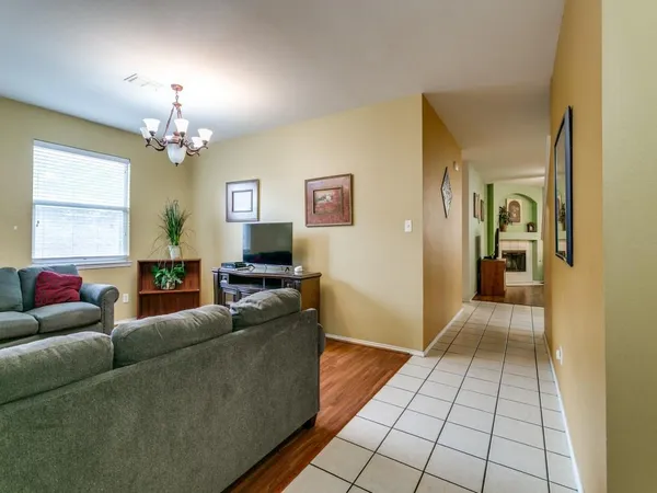 a living room with furniture and a chandelier