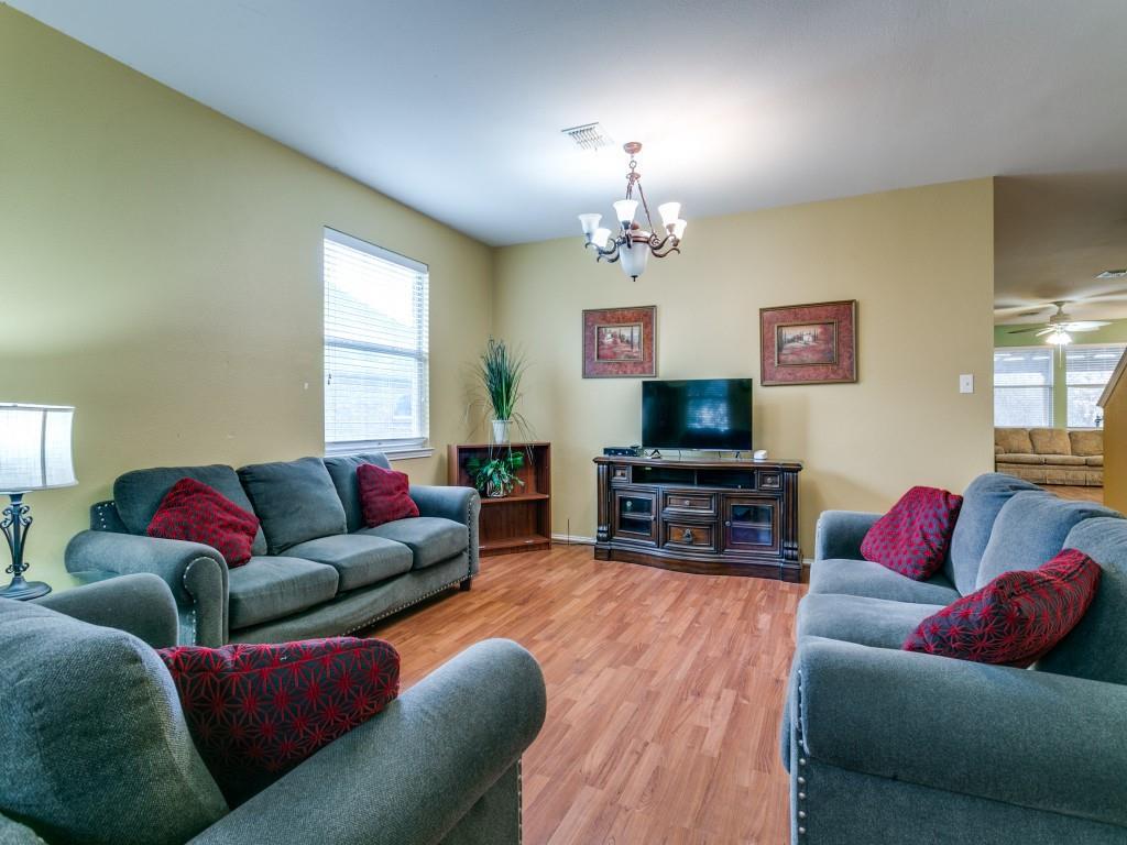 1105 Riverside Drive Lewisville, TX 75067 - Photo 7 of 40 a living room with furniture a flat screen tv and a fireplace