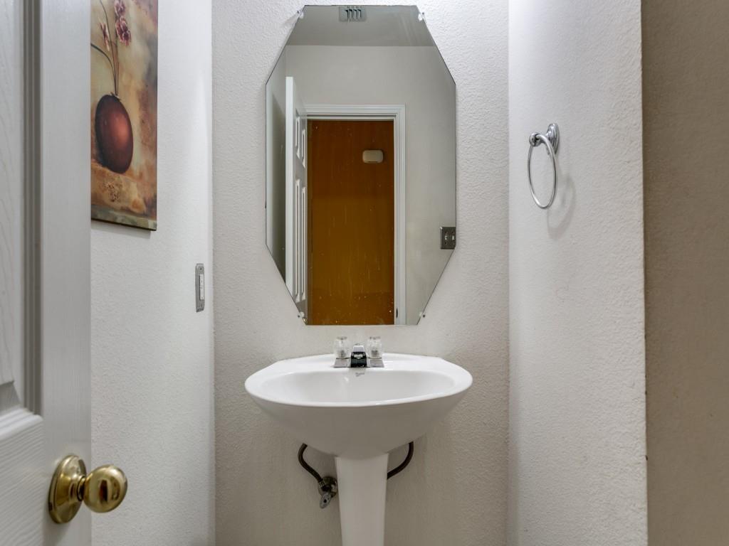 1105 Riverside Drive Lewisville, TX 75067 - Photo 10 of 40 a bathroom with a sink and mirror