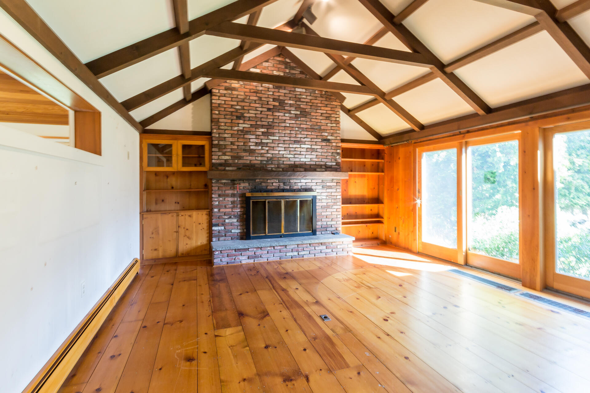 15 Jernegan Pond Road Edgartown, MA 02539 - Photo 11 of 31 a view of empty room with wooden floor and fireplace