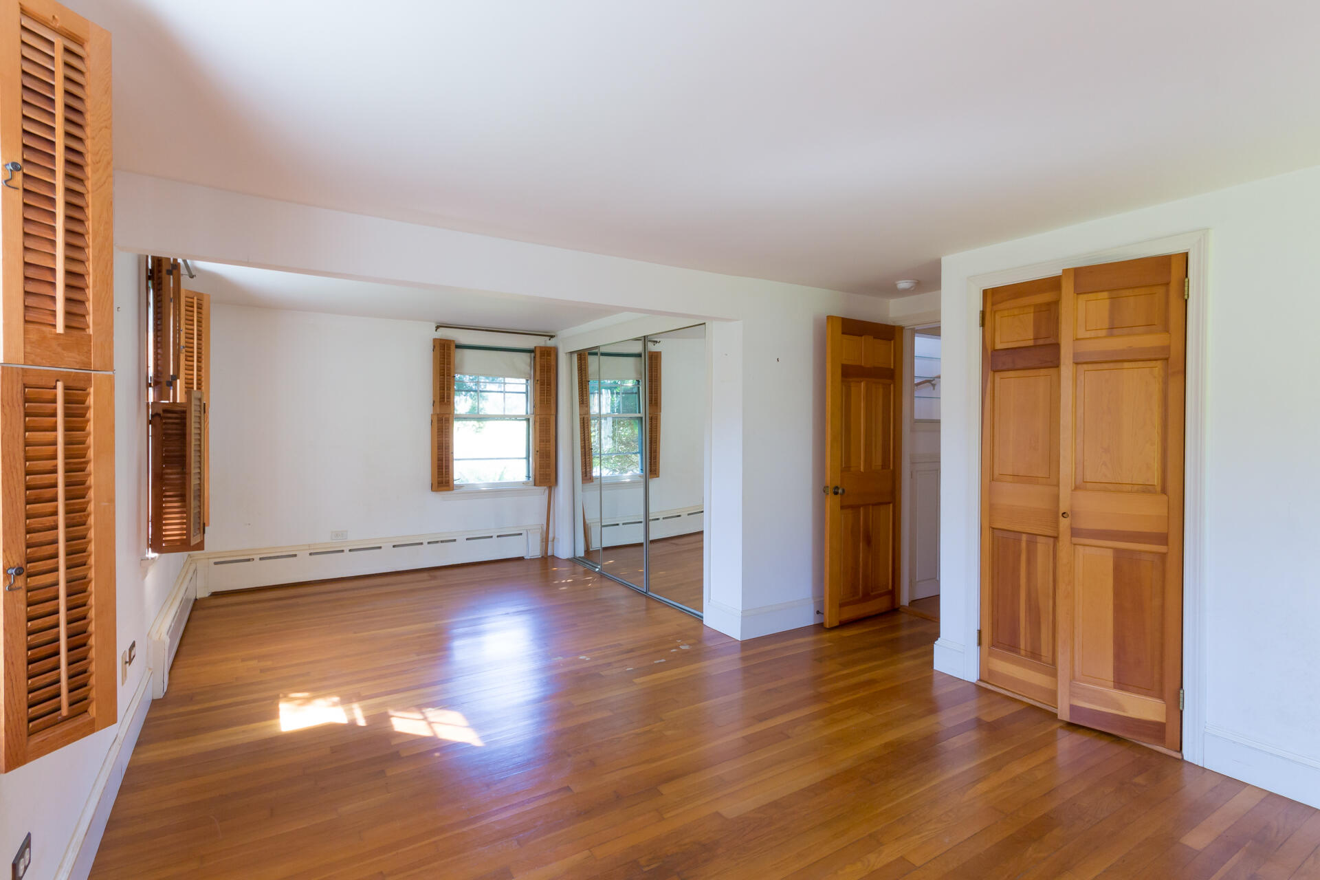 15 Jernegan Pond Road Edgartown, MA 02539 - Photo 21 of 31 an empty room with wooden floor and windows