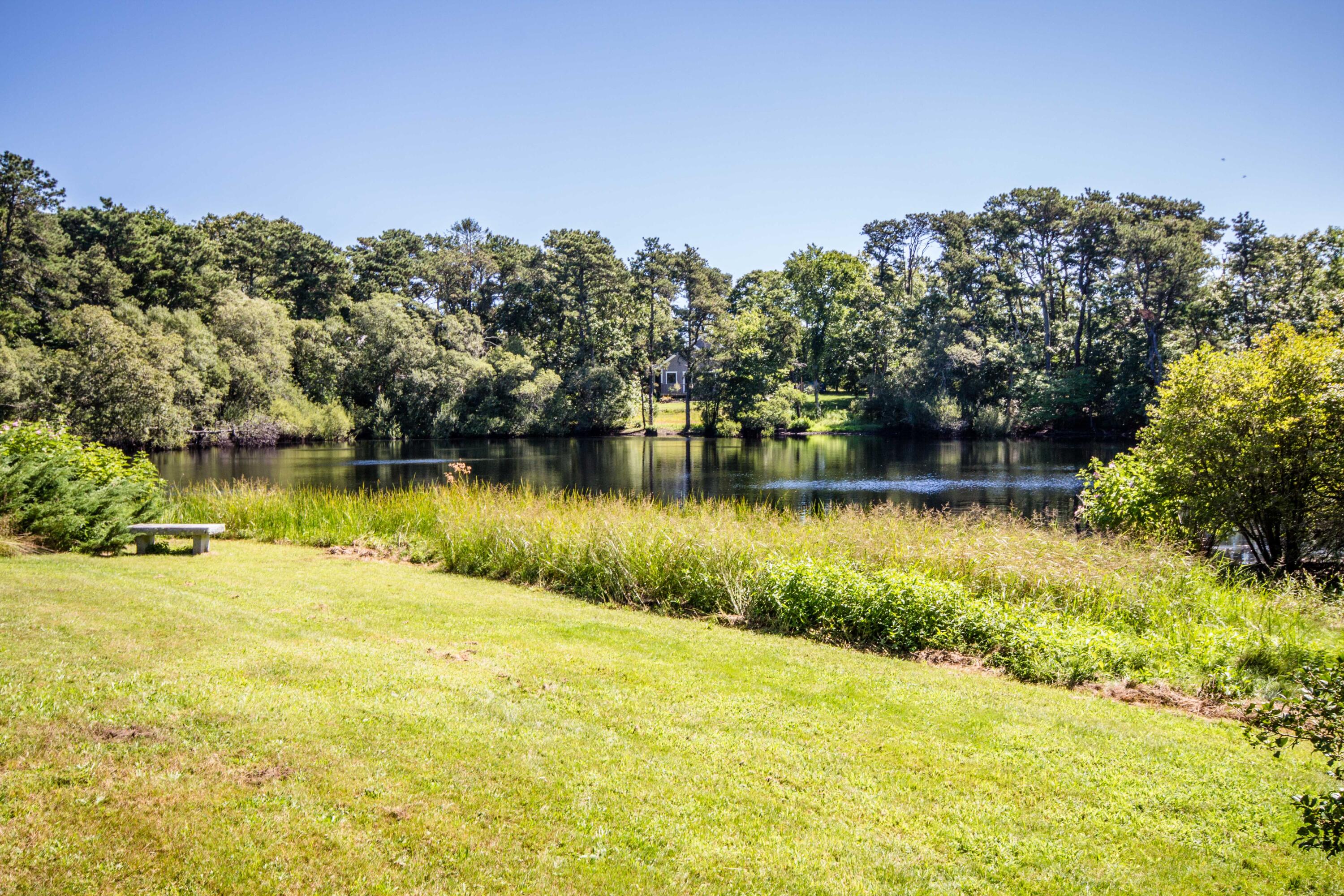 15 Jernegan Pond Road Edgartown, MA 02539 - Photo 4 of 31 a view of a lake with houses in the back