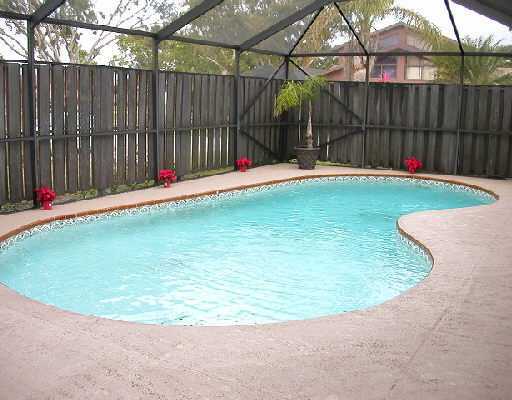 a swimming pool with wooden fence