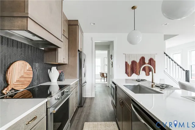 a kitchen with a stove a sink and a refrigerator