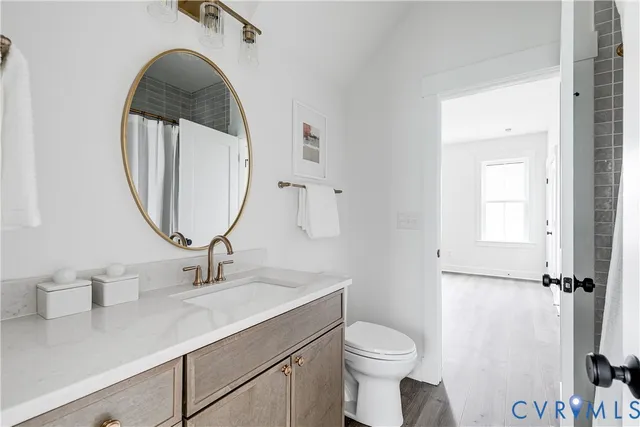 a bathroom with a toilet a sink and a mirror