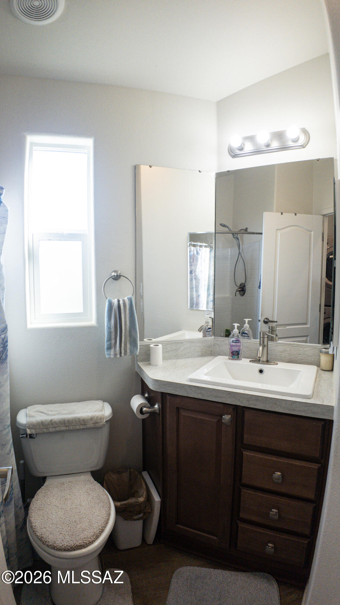1030 Barrel Cactus Ridge, Unit 230 Benson, AZ 85602 - Photo 8 of 12 a bathroom with a toilet sink and mirror