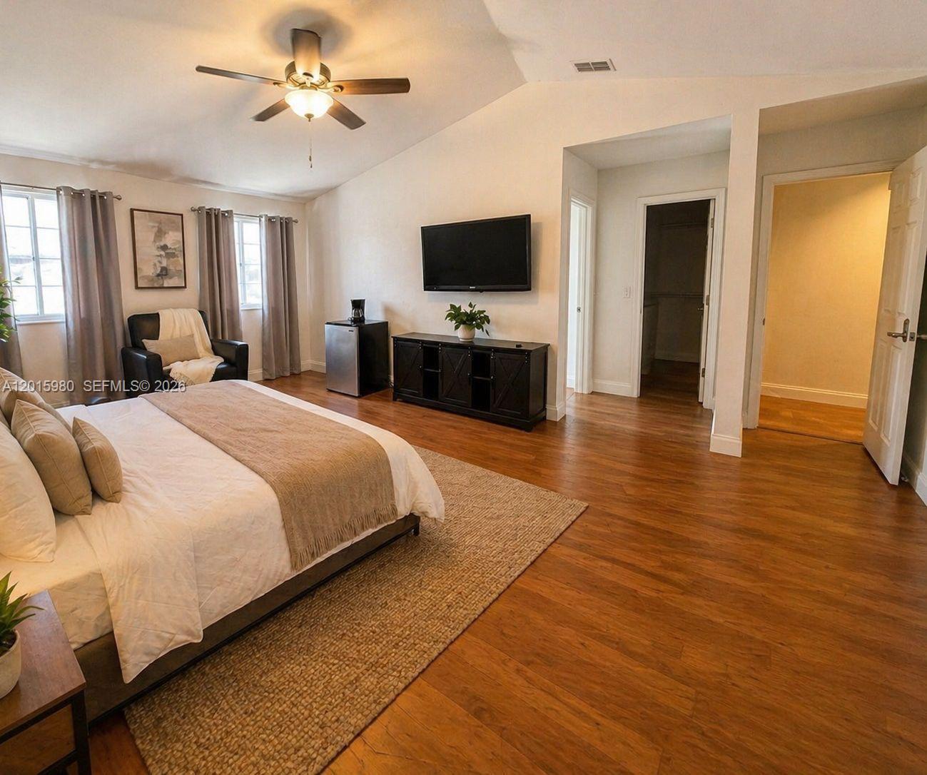 5402 Pointe Villa Drive, Unit B Lighthouse Point, FL 33064 - Photo 17 of 35 a bedroom with a bed and a flat screen tv