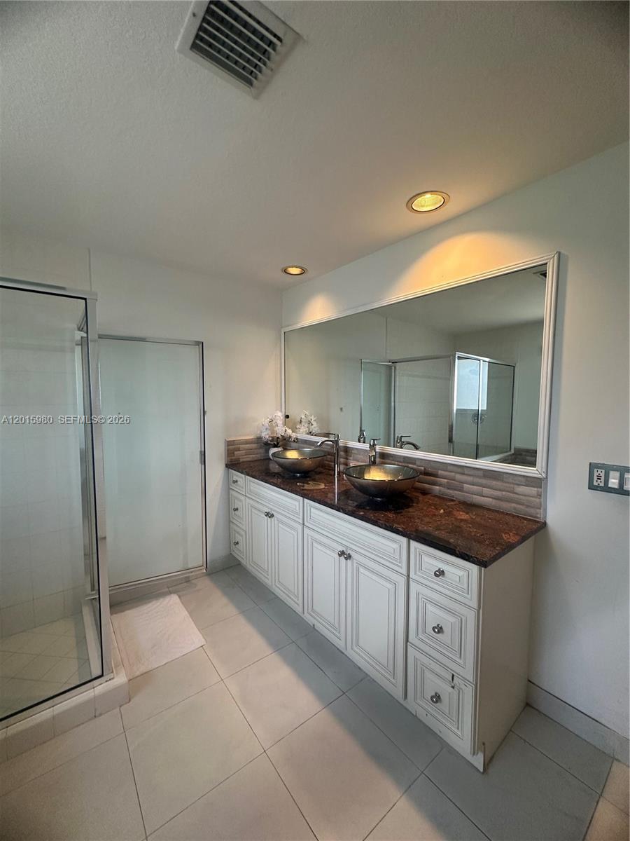 5402 Pointe Villa Drive, Unit B Lighthouse Point, FL 33064 - Photo 22 of 35 a large bathroom with a sink and a mirror