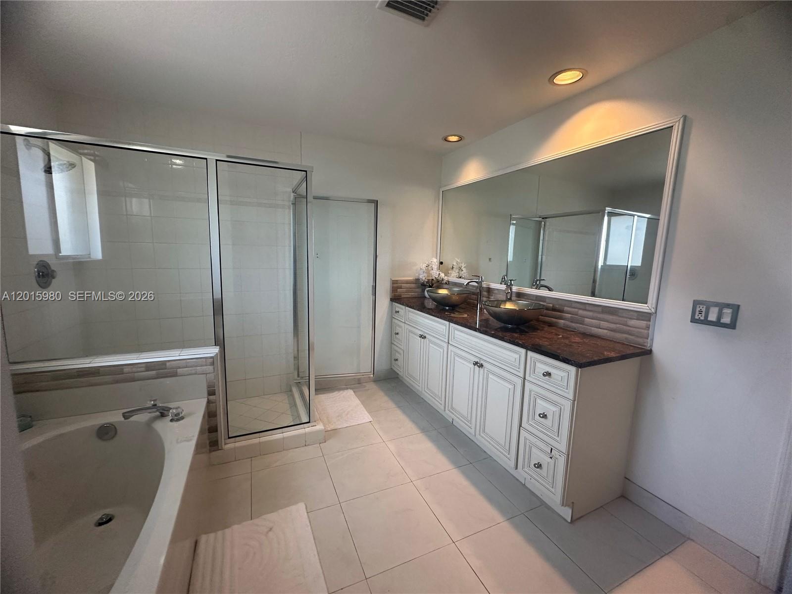 5402 Pointe Villa Drive, Unit B Lighthouse Point, FL 33064 - Photo 23 of 35 a spacious bathroom with a granite countertop sink a mirror and shower