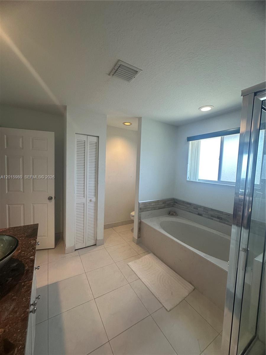 5402 Pointe Villa Drive, Unit B Lighthouse Point, FL 33064 - Photo 24 of 35 a spacious bathroom with a tub and shower