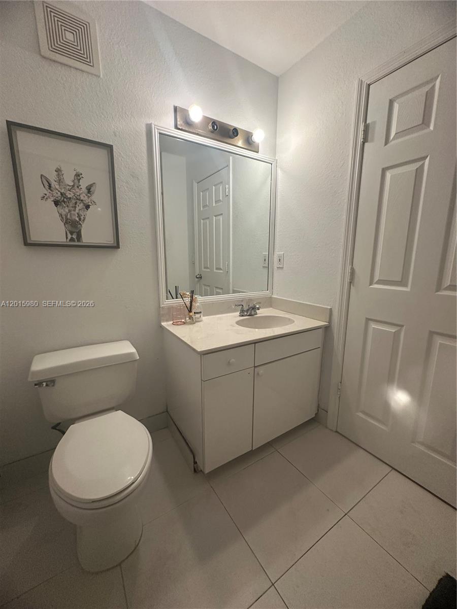 5402 Pointe Villa Drive, Unit B Lighthouse Point, FL 33064 - Photo 29 of 35 a bathroom with a sink mirror vanity and toilet