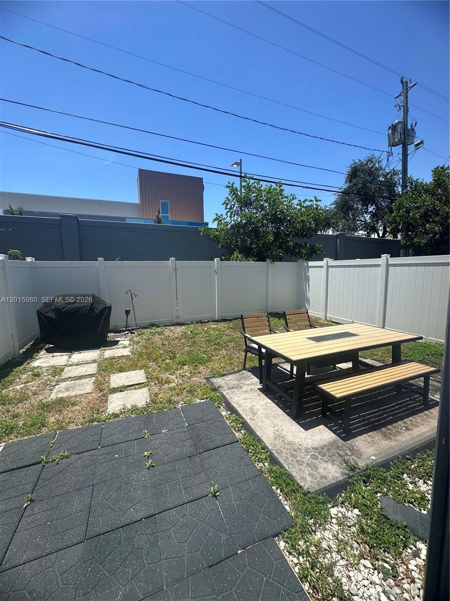 5402 Pointe Villa Drive, Unit B Lighthouse Point, FL 33064 - Photo 35 of 35 a view of a backyard with couches and wooden fence