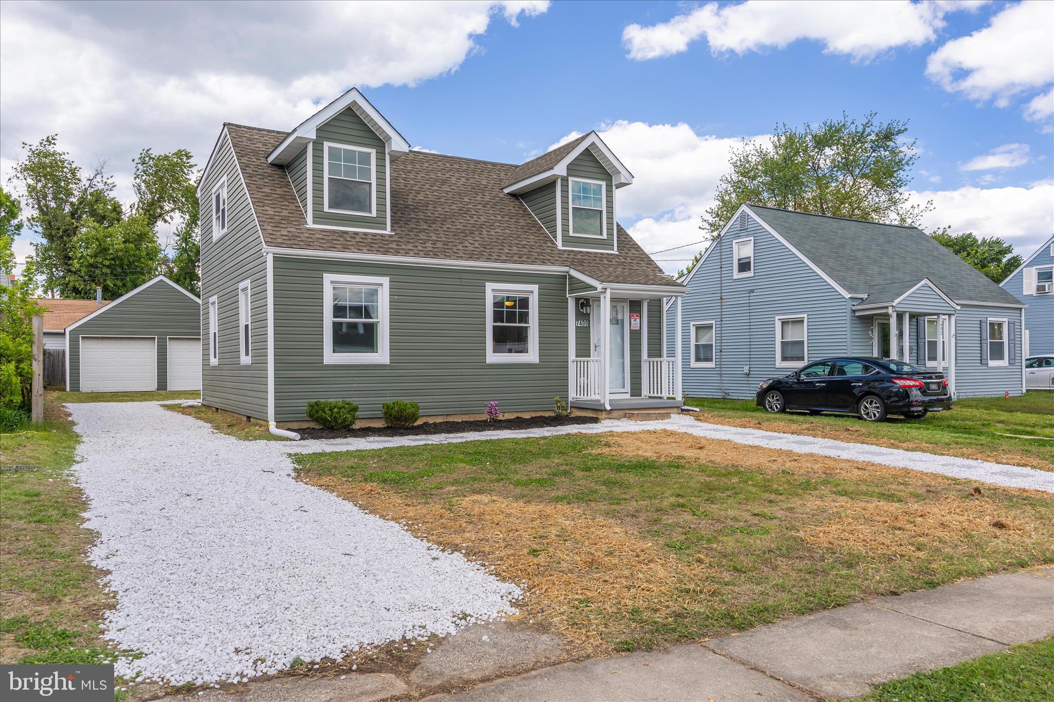 7400 Belclare Road Baltimore, MD 21222 - Photo 1 of 33 a front view of a house with a yard and garage