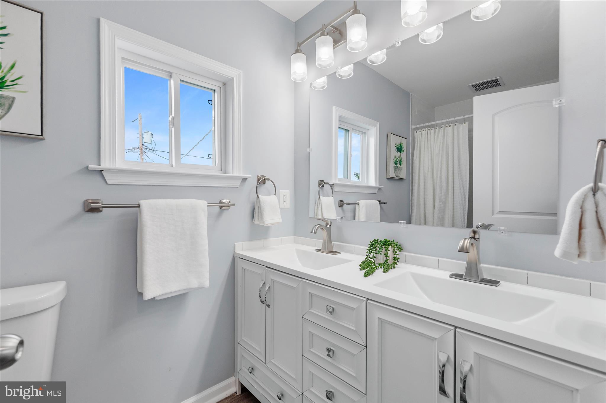 7400 Belclare Road Baltimore, MD 21222 - Photo 19 of 33 a bathroom with a sink a toilet and a mirror