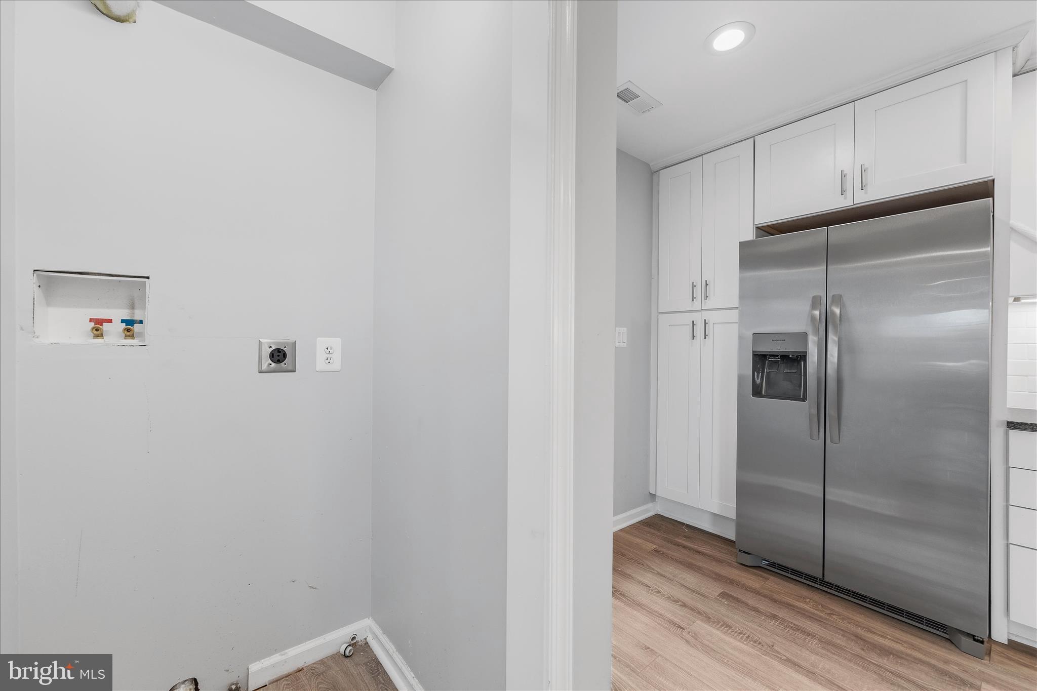 7400 Belclare Road Baltimore, MD 21222 - Photo 6 of 33 a kitchen with a refrigerator and wooden floor