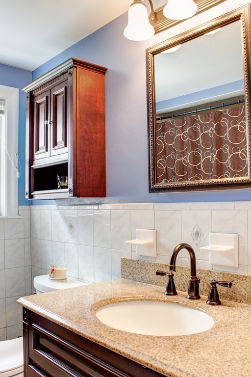 75 William Street Walpole, MA 02081 - Photo 17 of 27 a bathroom with a sink and a mirror