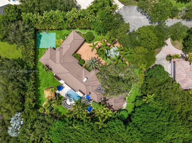 an aerial view of a house with a yard