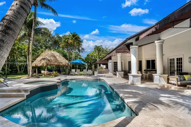 a view of a swimming pool with sitting area
